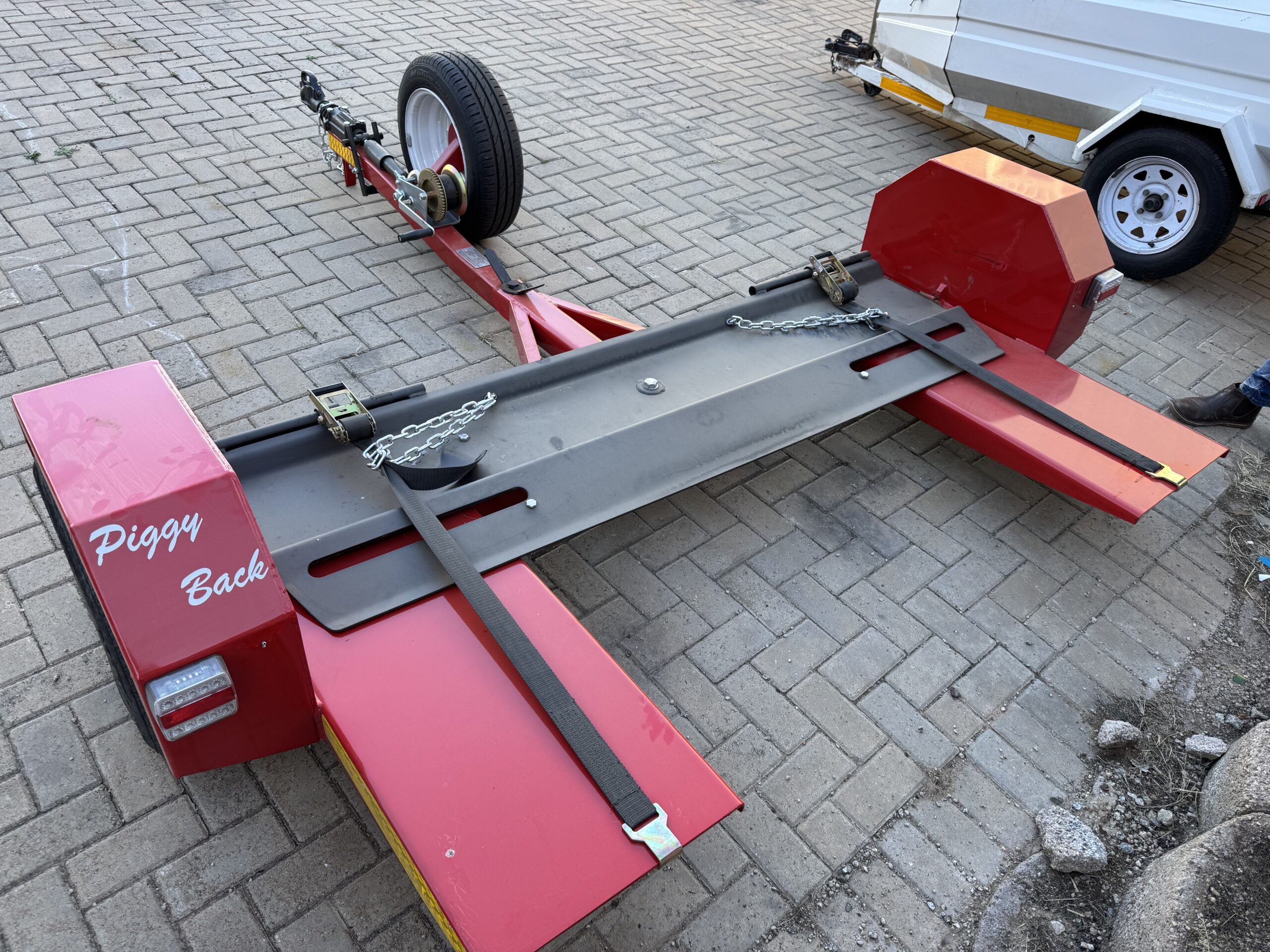 A Piggy-back Tow Dolly for moving vehicles at comfortable highway speeds